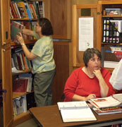 Meg and Sue organize the library.